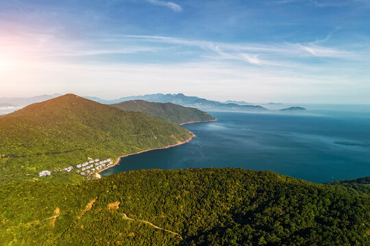 Aerial perspective shows Son Tra Peninsula jungle meeting the vast ocean in Da Nang, Vietnam