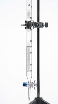 Glass burette clamped to a retort stand for titration isolated on white background