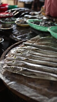 Fresh raw ribbonfish displayed on counter at Vinh Hai market in Nha Trang, Vietnam. Close up view of long silver hairtail fish at traditional Asian seafood wet market stall, local food concept.