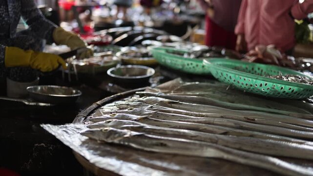 Fresh raw ribbonfish displayed on counter at Vinh Hai market in Nha Trang, Vietnam. Close up view of long silver hairtail fish at traditional Asian seafood wet market stall, local food concept.