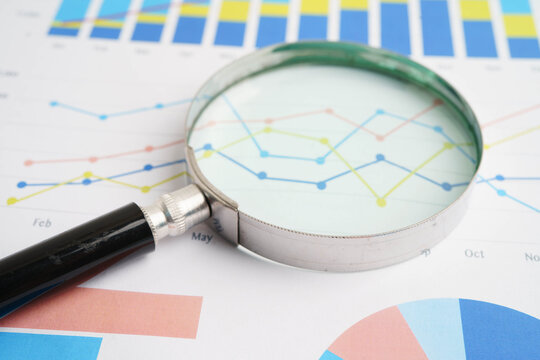Magnifying glass on charts graphs paper. Financial development, Banking Account, Statistics, Investment Analytic research data economy.