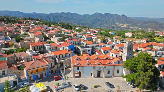 Aerial view of Pano Lefkara in Cyprus. The village church, red rooftops and surrounding mountains create a beautiful traditional Cypriot landscape.