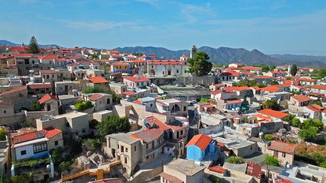 Drone view of Pano Lefkara village in Cyprus. Red rooftops, narrow streets, stone houses and mountain scenery create a charming traditional village panorama.