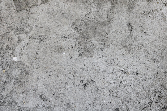 Weathered light grey concrete floor texture background.
