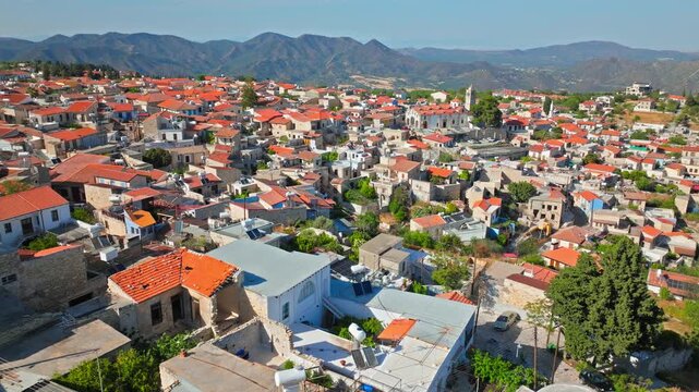 Drone view of Pano Lefkara in Cyprus. Stone houses, terracotta rooftops and green countryside form a beautiful traditional village landscape.