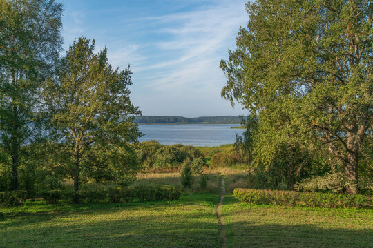 A descent to Kuchane Lake from the Petrovskoye Estate of the Natural Landscape Reserve A. S. Pushkin on a sunny summer day, Pushkinskiye Gory, Pskov Region, Russia