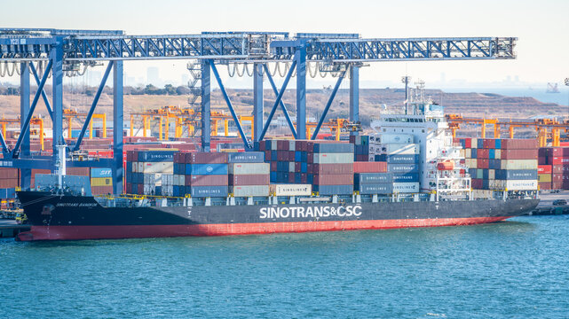 Container ship of Sinotrans Chinese logistic company at port dock with cranes in Tokyo Japan