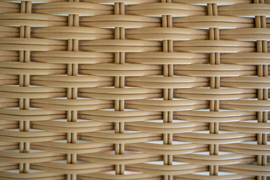 Woven rattan texture background. Close up of light brown wicker basket weave pattern.