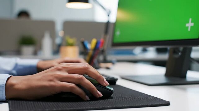 Professional Hand Using Computer Mouse in Modern Office with Green Screen Monitor