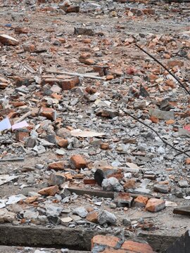 Broken red bricks and concrete rubble at a construction demolition site