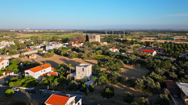 Aerial view of Kolossi Castle in Cyprus, showing the medieval fortress within the surrounding village and open countryside.