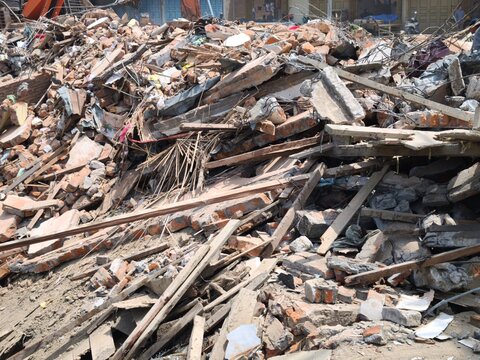 Large pile of rubble and debris after building demolition site disaster
