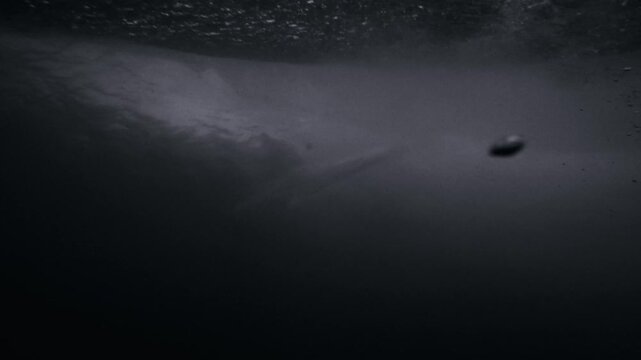 a surfer in a barrel through the back of a wave
