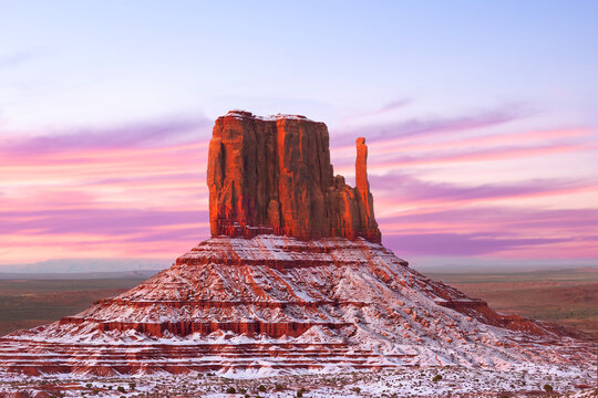 Monument Valley Butte Silhouette at Sunrise with Desert Mist and Vibrant Dawn Sky, Arizona, Utah, US