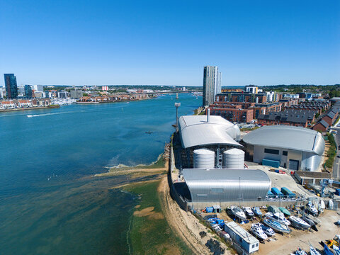Aerial view of the Woolston Water Treatment Plant with metallic storage tanks and industrial buildings along the River Itchen, Southampton, England, United Kingdom.