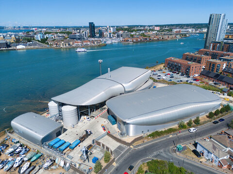 Aerial view of the Woolston Water Treatment Plant featuring modern metallic curved buildings and industrial tanks situated along the River Itchen in Southampton, England, United Kingdom.