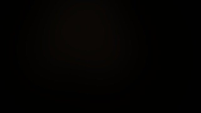 Soft golden light transitions moving across a dark screen texture creating elegant cinematic visual atmosphere in this professional motion video footage perfect for background overlays and artistic ab