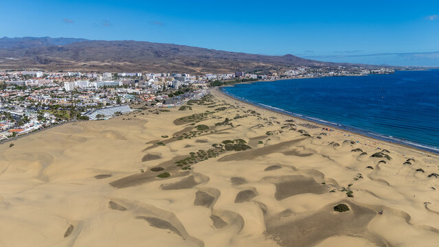 Aerial panorama view of Maspalomas Dunes, hotels in Playa del Ingles, beach, Atlantic ocean and mountains on Canary Island Gran Canaria, Spain