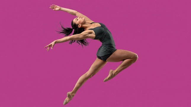 Graceful female modern dancer jumping in mid-air against purple studio background