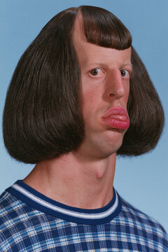 people of ai, yearbook photo of a person with dark-brown bowl bob with curled ends, exaggerated puckered lips, navy plaid sweater, photorealistic.png
