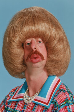 people of ai, yearbook photo of a person with huge light-brown rounded bouffant, goofy puckered lips, red-teal patterned blouse with white collar and pearls, photorealistic.png