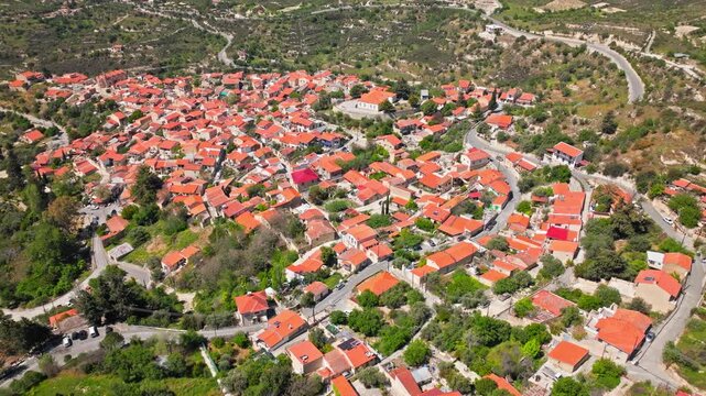 Aerial view over Omodos in Cyprus. Dense terracotta rooftops, narrow village streets and surrounding countryside show the beauty of this traditional Cypriot village.