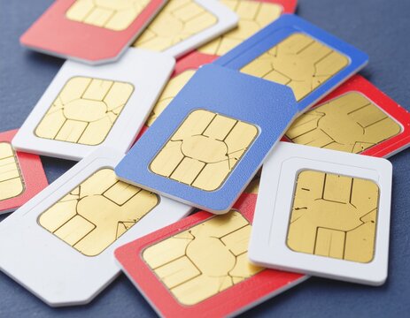 A heap of colorful SIM cards with gold chips for mobile phone communication and global connectivity