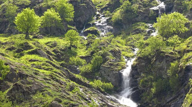Scenic Waterfall Cascading Down Rocky Cliffs at Lago della Rovina