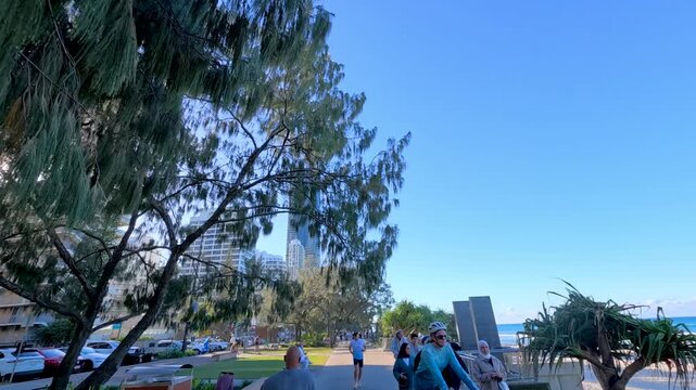 Pedestrians Walking Along Surfers Paradise Esplanade with City Skyline View
