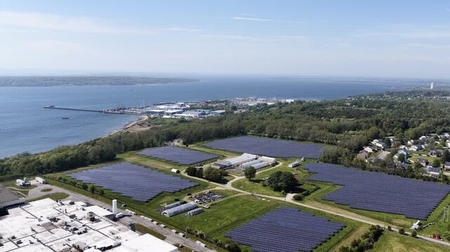 Aerial view of solar farm beside a residential neighborhood in Portsmouth, Rhode Island, USA. Sustainable energy. g.