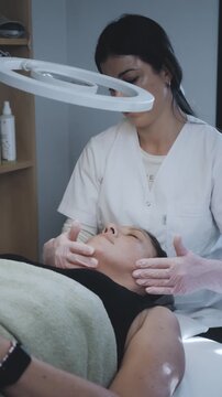 Aesthetic Practitioner Performing Manual Facial Massage and Skincare Application in Clinical Treatment Room
