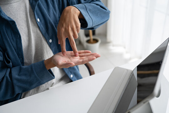 Close up of man using sign language for ASL for accessible online learning and virtual communication.