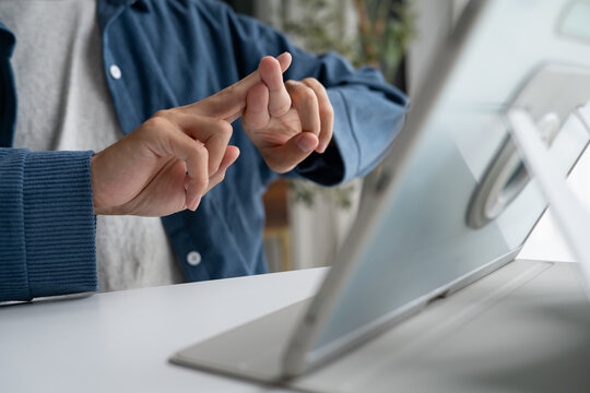 Close up of man using sign language for ASL for accessible online learning and virtual communication.