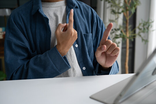 Close up of man using sign language for ASL for accessible online learning and virtual communication.