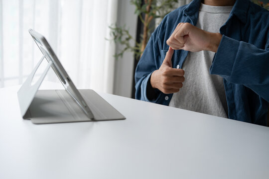 Close up of man using sign language for ASL for accessible online learning and virtual communication.