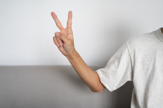 Close up of deaf man using sign language for ASL communication and learning concept.