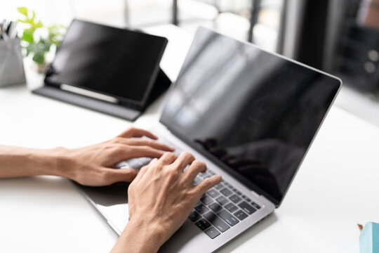Man typing on laptop keyboard for remote work and digital business technology concept