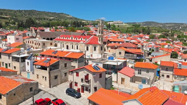 Aerial view of traditional houses in Omodos, Cyprus. Red tiled rooftops, stone buildings and narrow village streets create an authentic cultural travel view.