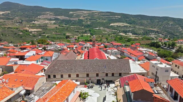 Aerial view of the Holy Cross Monastery area in Omodos, Cyprus. Historic stone buildings, red tiled roofs and the village centre create a cultural landmark scene.