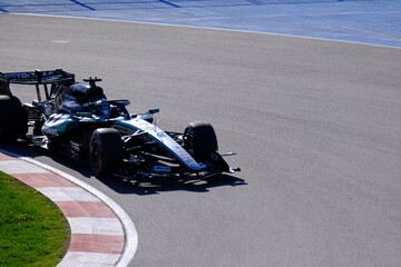 Obraz premium May 24, 2026, Montreal, Canada, Mercedes F1 car racing through Circuit Gilles Villeneuve corner. g.