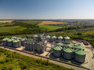 Elevated panoramic perspective of modern agricultural grain storage facility with green roof metal silos built in rural landscape. © Pasha