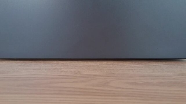 Asian woman opening black laptop on wooden desk. Close up hands opening notebook computer, start work, business, productivity, technology, WFH.