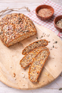 Delicious paleo keto bread made with seeds and nuts on a wooden board