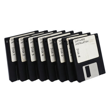 Stack of eight vintage floppy disks for software installation
