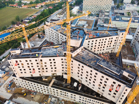 Aerial view of the new F. D. Roosevelt University Hospital building under construction with multiple yellow tower cranes and concrete structure in Banska Bystrica, Banskobystricky kraj, Slovakia.