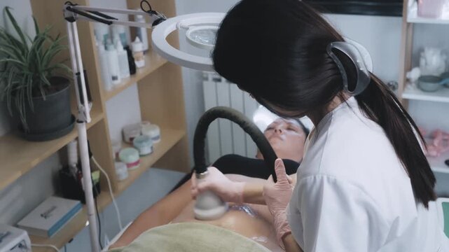 Esthetician Using Handheld Radiofrequency and Cryotherapy Device for Targeted Treatment at Aesthetic Center