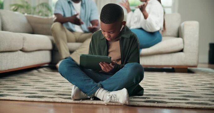 Son, tablet and black child with parents fighting in home for argument, conflict or divorce. Kid, ignore or playing with technology, mom or dad in disagreement for break up, separation or dispute