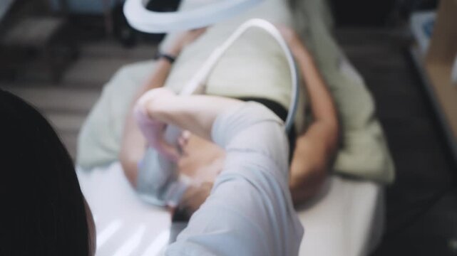 Aesthetic Practitioner Performing Precision Facial Treatment With Handheld Technology on Seated Client