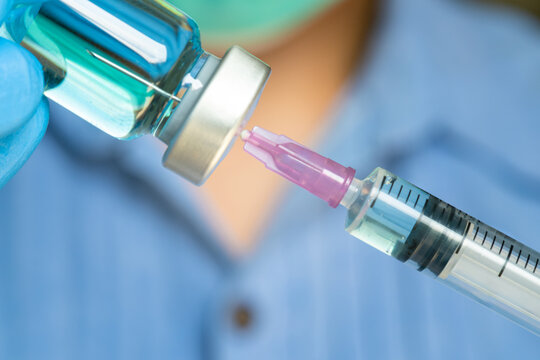 doctor uses a syringe to dispense medication from the bottle. at the hospital. Health and medical concepts	
