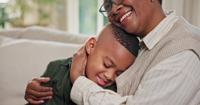 Mom, kid and black family with hug on sofa for love, care or bonding together in home. Happy, mother and smile with child, son or embrace on couch for comfort, weekend break or holiday in house